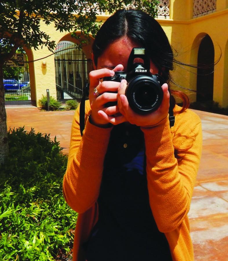 Junior Lidia Zamora taking a picture at school