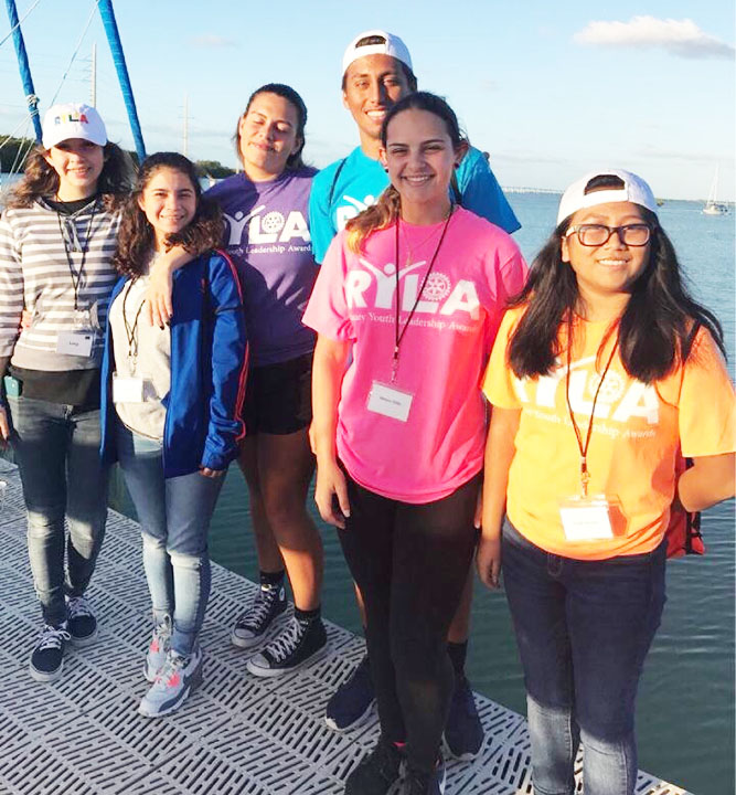 (From Left to Right) Lucy Galeano, Alexa Melgar, Elizabeth Astacio, OlvinVillatoro, Melanie Millo, and Mingli Yactayo hanging out on the dock.