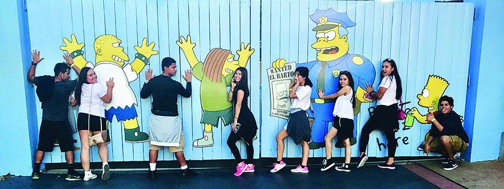 From left to right: Seniors William Villalta, Maryelin Leal, Mark Granados, Allison Lazo, Elizebeth Davila, Maria Maldonado, Noemi Martinez, and Carlos Moreno posing near the Simpsons ride in Universal Studios.