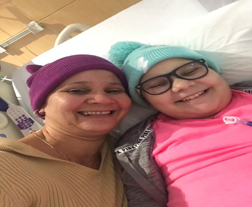 November 2nd, 2017 - This picture was taken during my second chemotherapy. In the picture you can see my 
mom and I taking a selfie in our hospital room wearing beanies and smiling.
