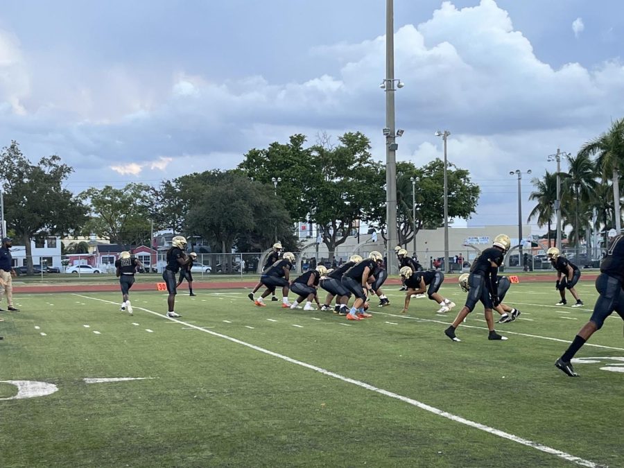 Football team running plays before the Krop game at Curtis Park. 
