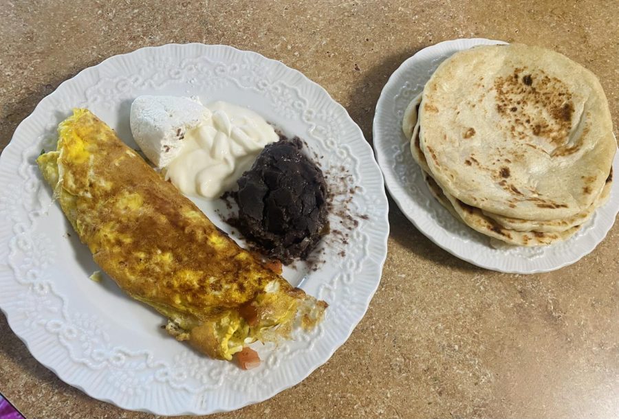 An Omelette I made with black beans, cheese, crema and tortillas on the side. 