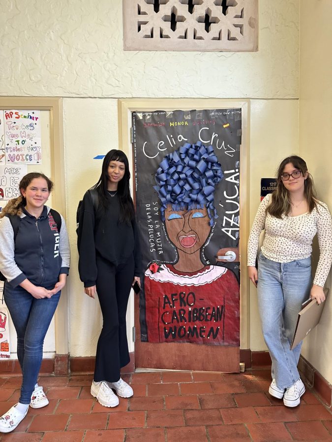 SNHS Historians Maria Leyva and Andrea Didonato (on the left) designed the Celia Cruz door for the club, and club president Rocio Pelaez (on the right)