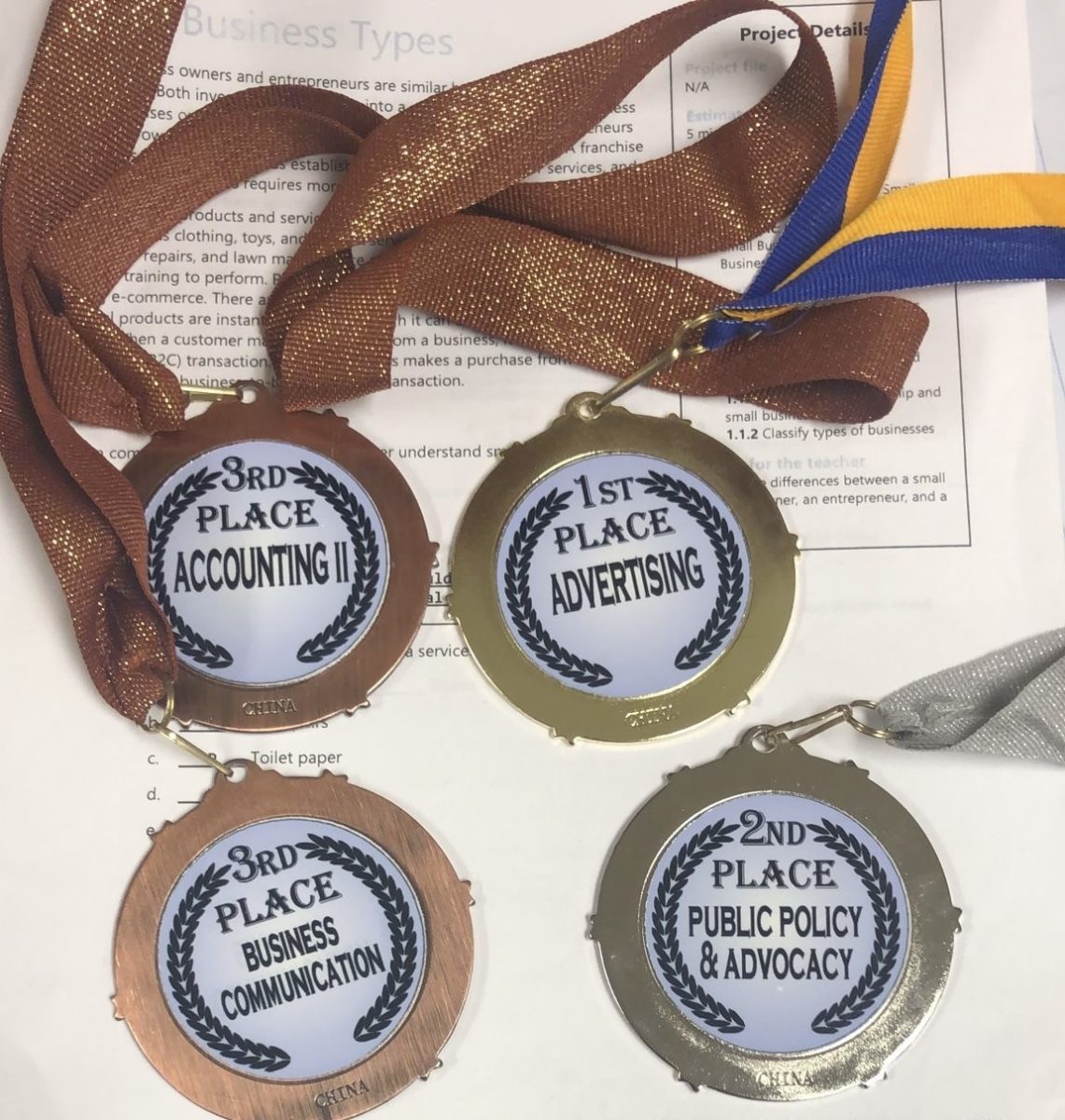 Four medals that were awarded to last year's event winners.