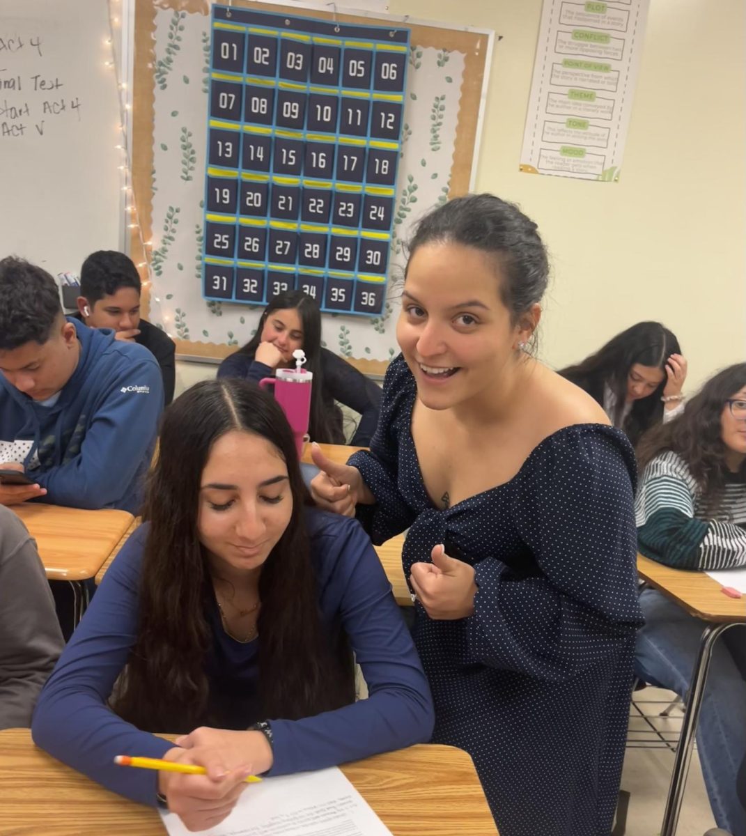 In this picture, we see Ms. Gonzalez with one of her students who's taking a test.