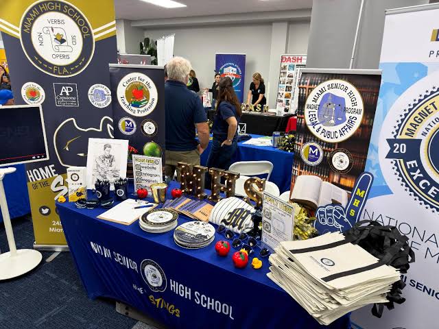 A booth for Miami Senior High demonstrating AP Course offerings and other activities.