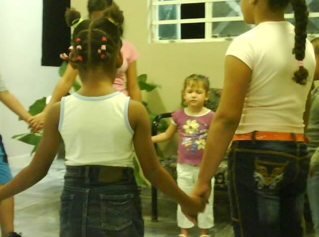 Senior Viviany Diaz  praying at a kids event in her home church at La Habana Cuba  at the young age of 4 years. 